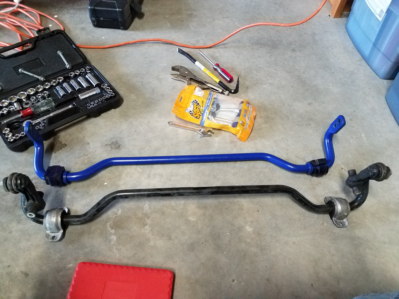 Here you see the OEM sway bar below the SuperPro sway bar, with the SuperPro endlinks in the yellow bag above. Crow bar was not needed for the brackets (seen here still on the OEM bar bushings).